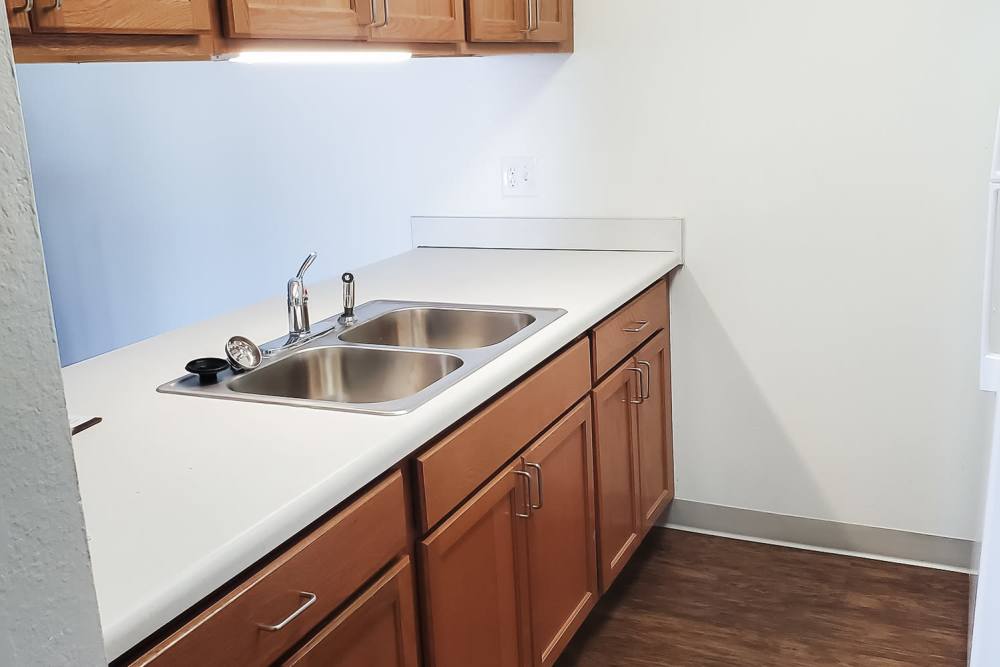 Model kitchen with hardwood floors at Mapleview Apartments in Maple Rapids,