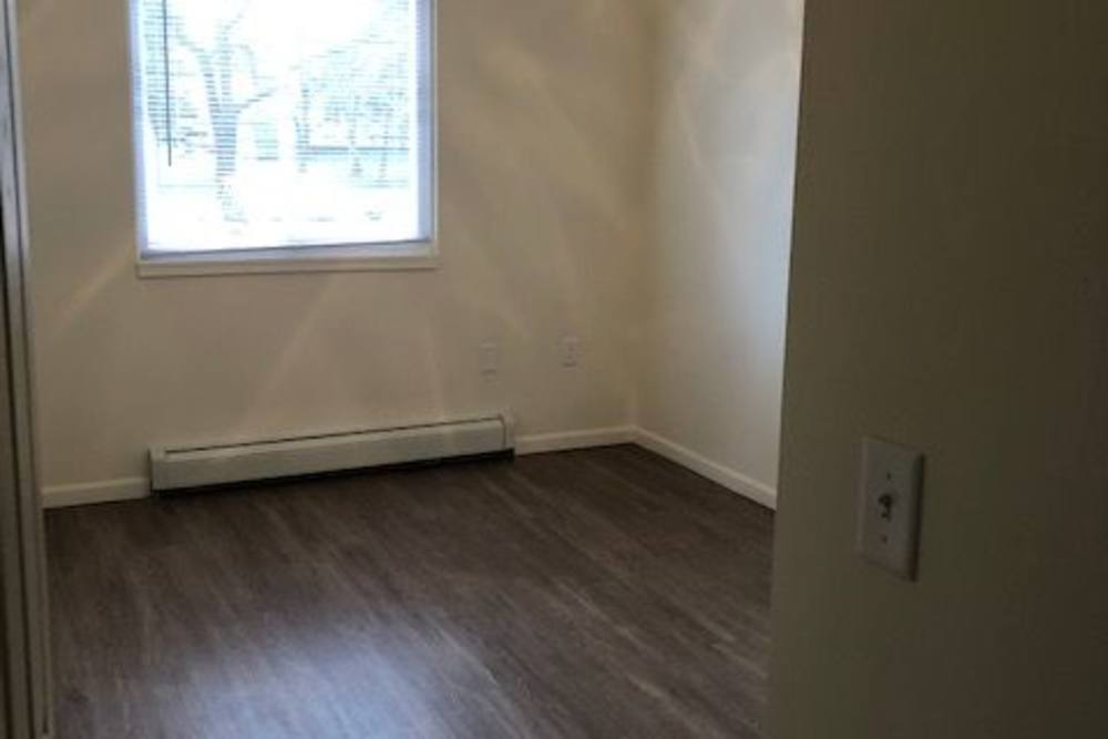 Model bedroom space with windows at Franklin Pointe in Reed City,