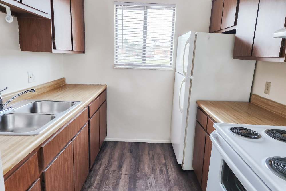 Kitchen with white appliances at Mill Pond Apartments (Buchanan) in Buchanan,
