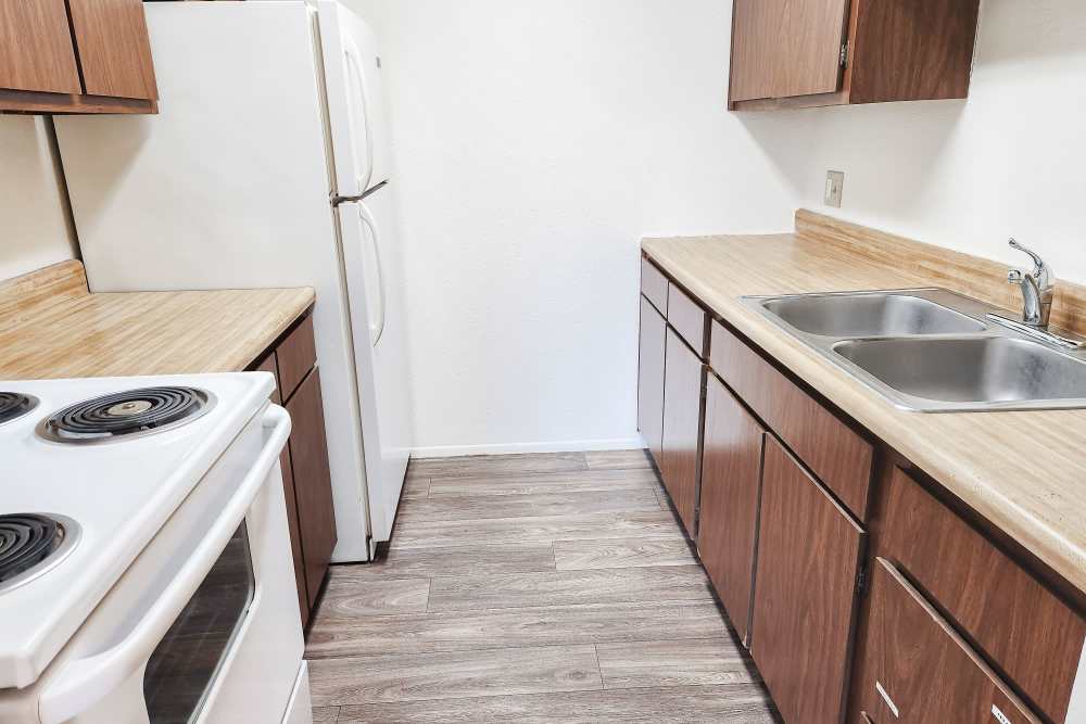 Model kitchen with hardwood floors at Mill Pond Apartments (Buchanan) in Buchanan,