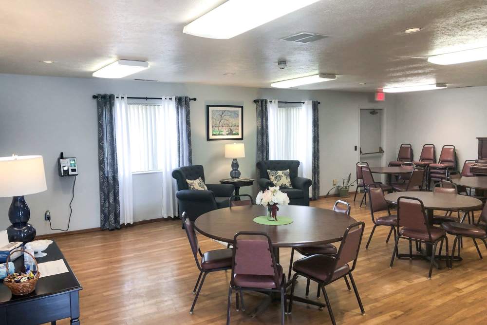 Community room with tables at Mill Pond Apartments (Buchanan) in Buchanan, Michigan