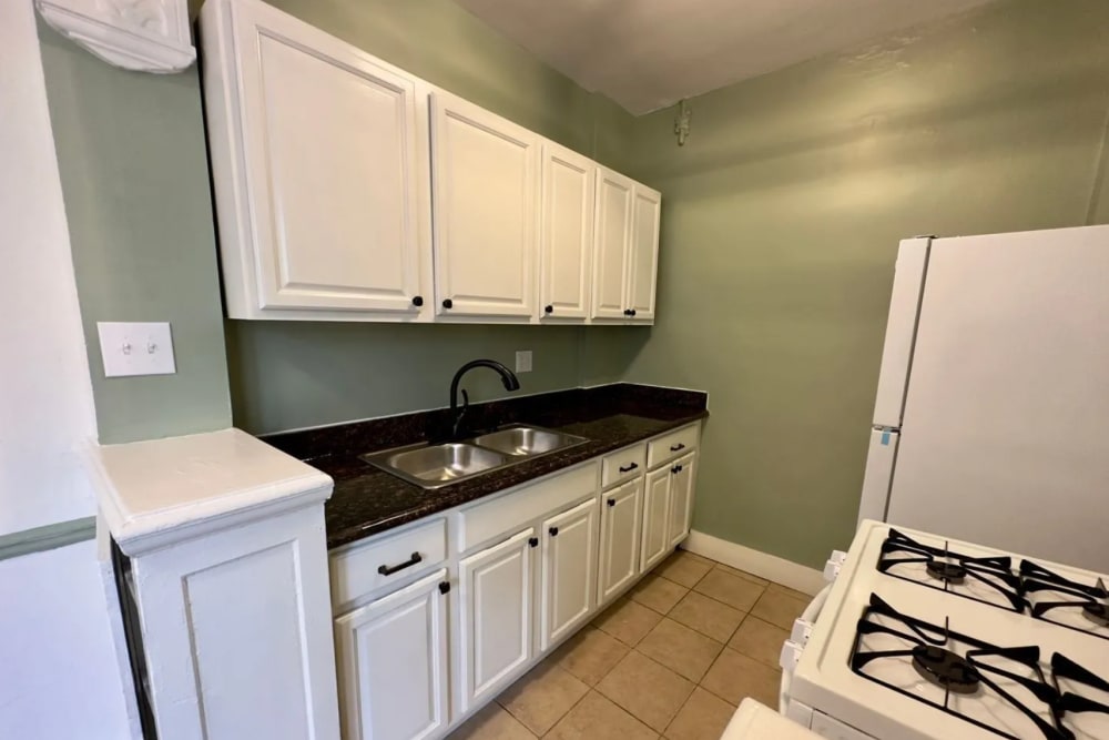 Kitchen with white appliances and cabinetry at Detroit Living in Detroit,Michigan