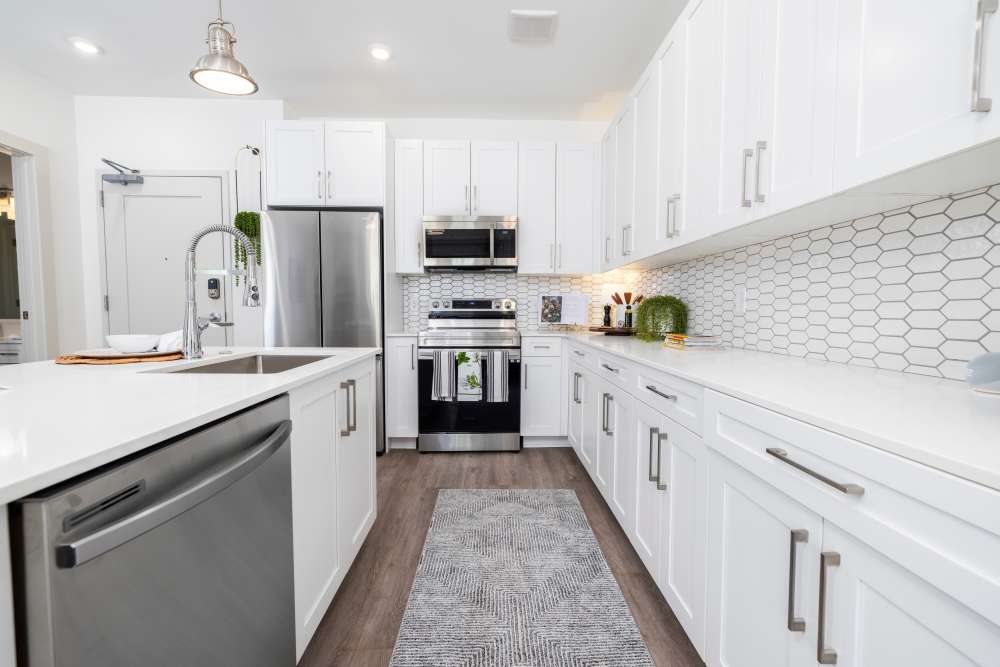 White cabinets in an apartment kitchen at The Lowe in Savannah, Georgia