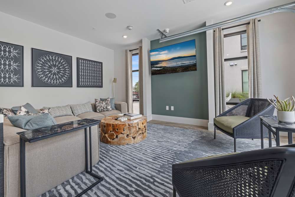 A couch and arm chairs in a model apartment living room at The Lowe in Savannah, Georgia