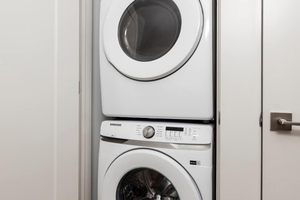 A stacked washer and dryer in an apartment at The Lowe in Savannah, Georgia