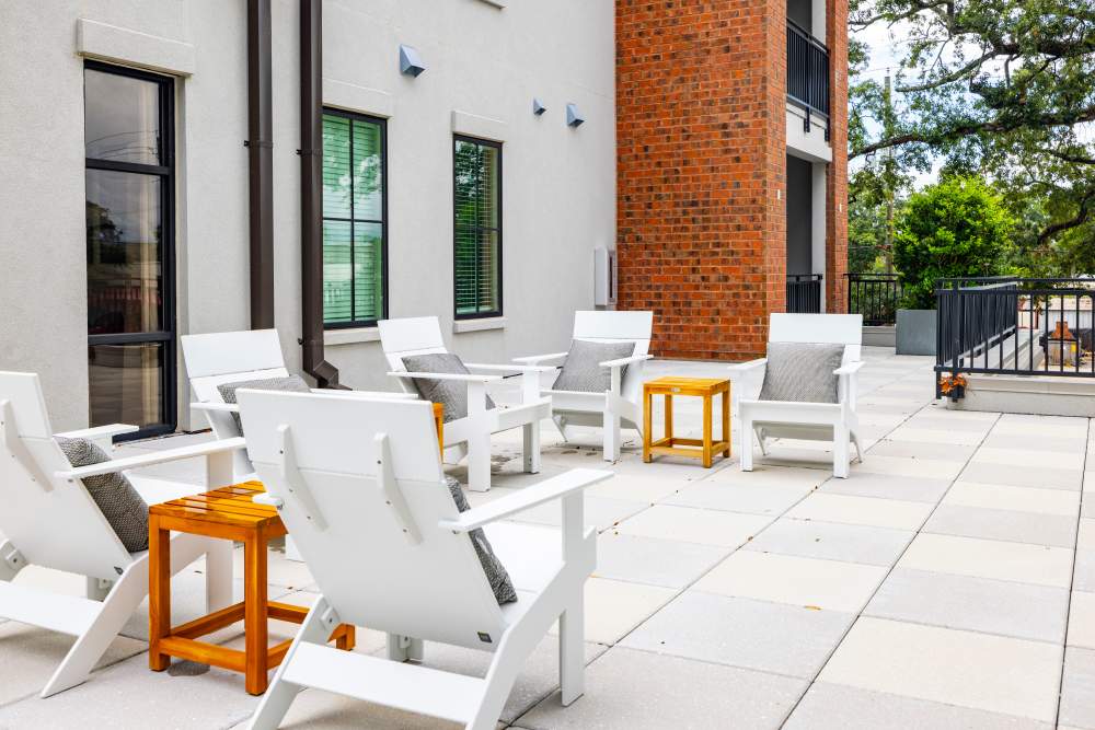 An outdoor seating area with side tables at The Lowe in Savannah, Georgia