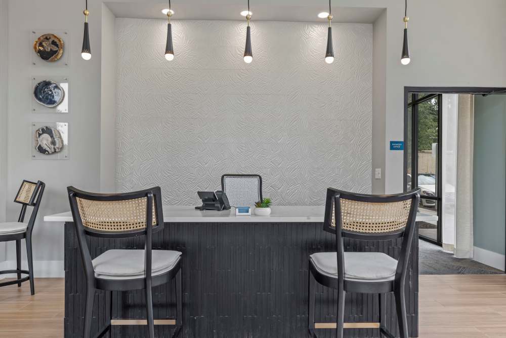 Seating facing a leasing office table at The Lowe in Savannah, Georgia