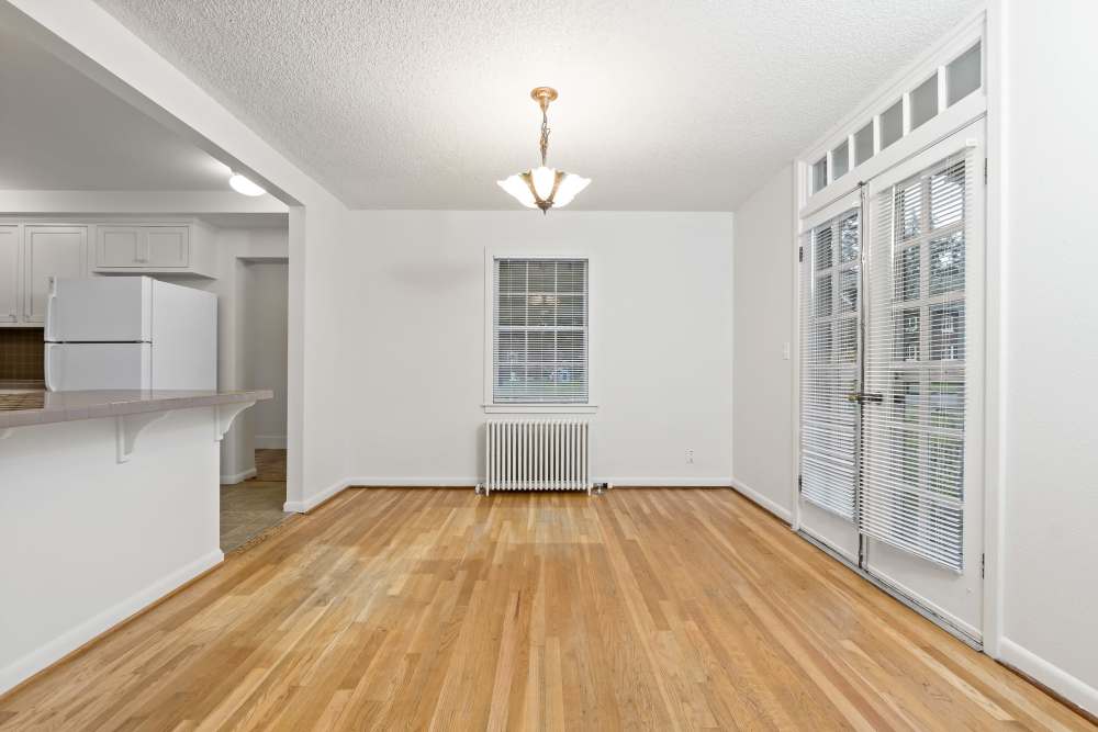 Broadmoor community open concept dining room with hardwood floors