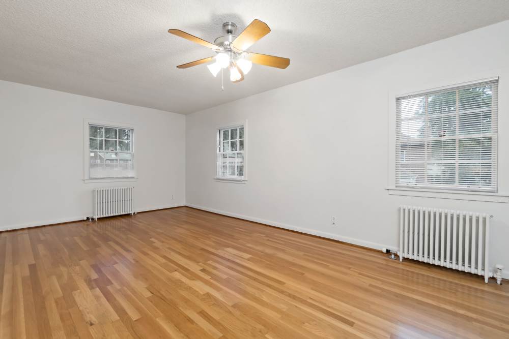 Broadmoor Community Master Bedroom with Hardwood Floors and Ceiling Fan