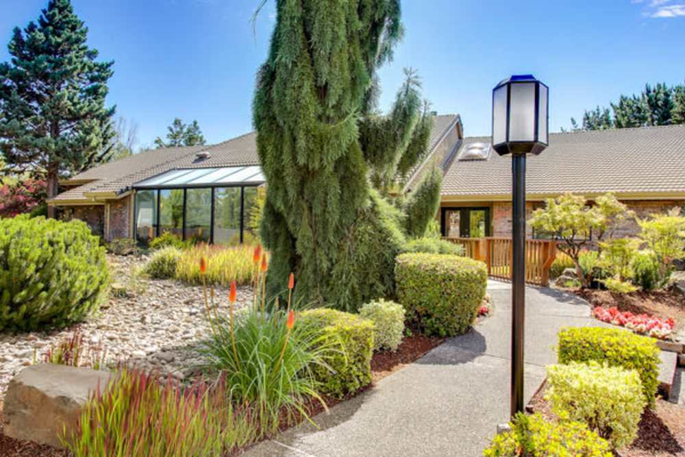 Path leading to the apartment building with trees all around at Ansley Murrayhill in Tigard, Oregon
