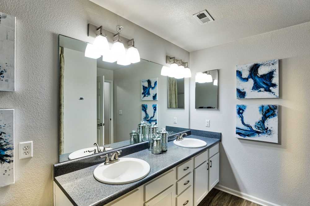 Bathroom with a large mirror and proper lighting at Eastland Trails in Independence, Missouri