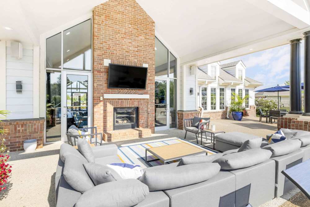 Outdoor seating area with a large TV at Eastland Trails in Independence, Missouri