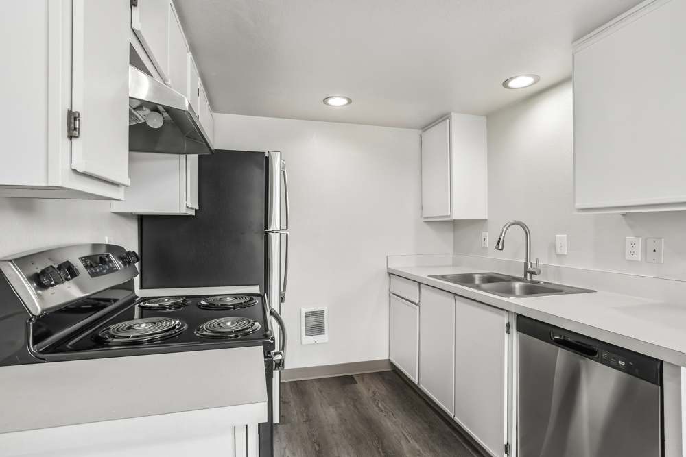 Modern kitchen with white cabinets and stainless steel appliances at Cascade Ridge in Madras, Oregon