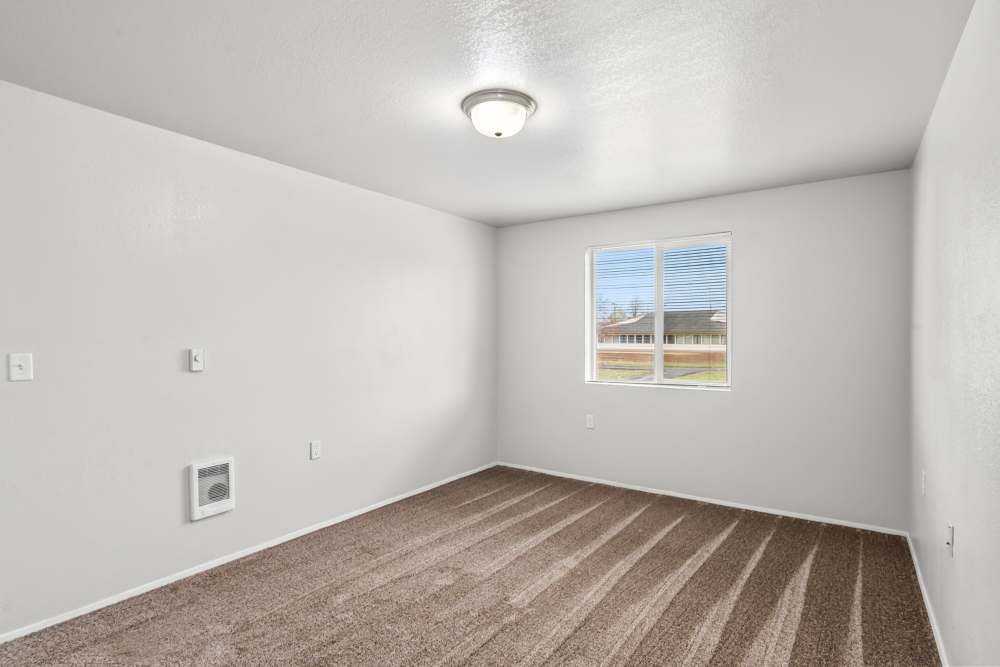 Well-lit room with white walls and new brown carpet at Cascade Ridge in Madras, Oregon