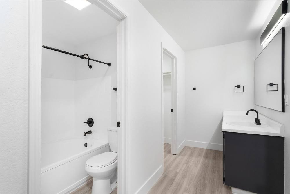 Bathroom with wood-style flooring at The Rosewood Apartments in Vancouver, Washington