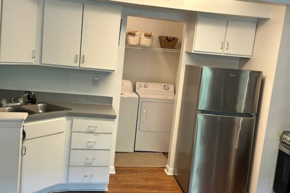 Apartment Kitchen and Laundry Room at The Quarters Starkville in Starkville, Mississippi