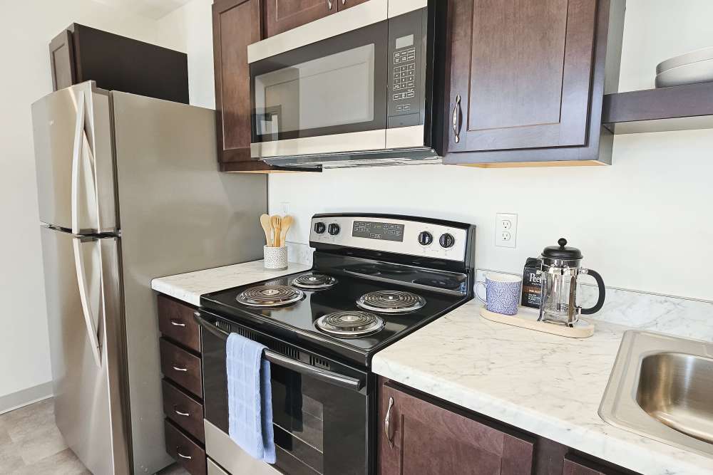 Stainless-steel fridge in a kitchen at Academy Manor in Grand Rapids, Michigan
