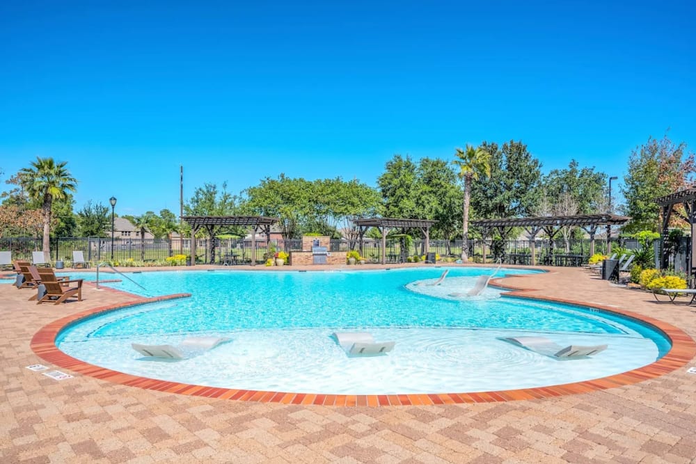 Resort-style swimming pool at The Abbey at Park Lakes in Humble, Texas