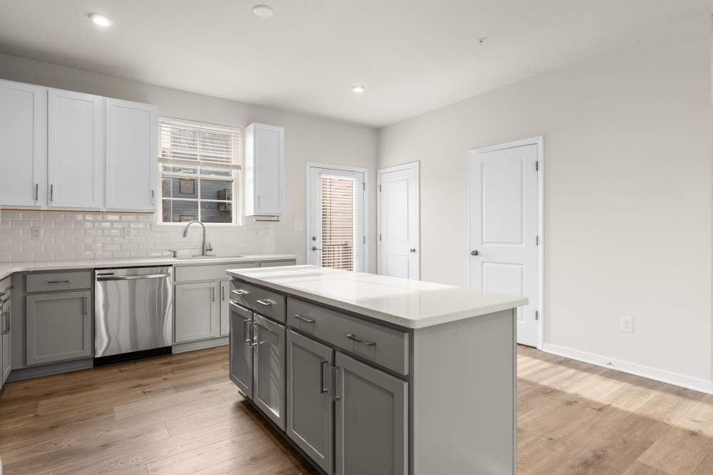 Townhome kitchen with island and granite countertops at The Westbrook at Brewer's Row in Richmond, Virginia