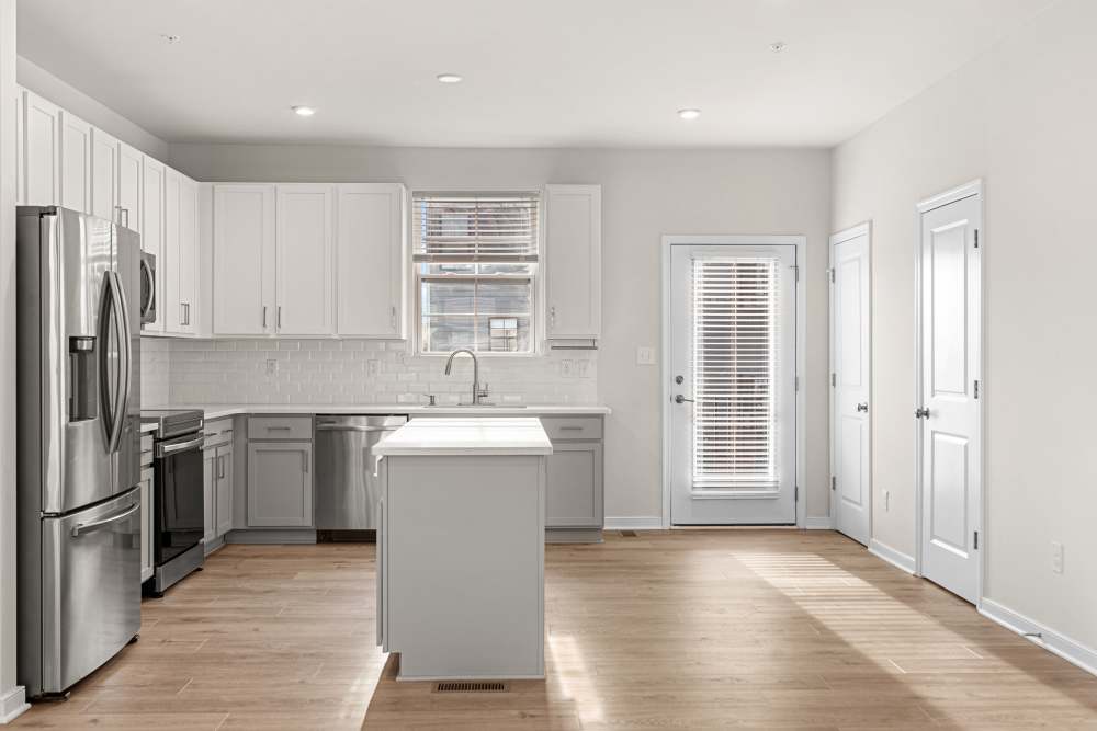 Townhome kitchen with plank flooring at The Westbrook at Brewer's Row in Richmond, Virginia