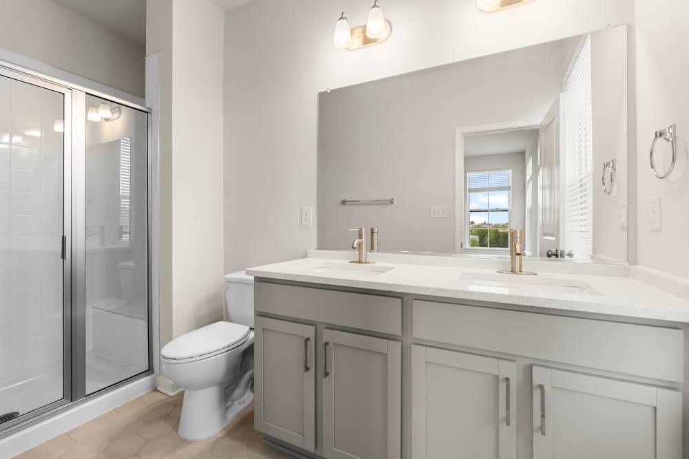 Bathroom with dual vanity and walk-in shower at The Westbrook at Brewer's Row in Richmond, Virginia