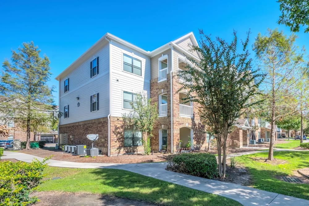 Exterior view of community apartment at The Abbey at Park Lakes in Humble, Texas