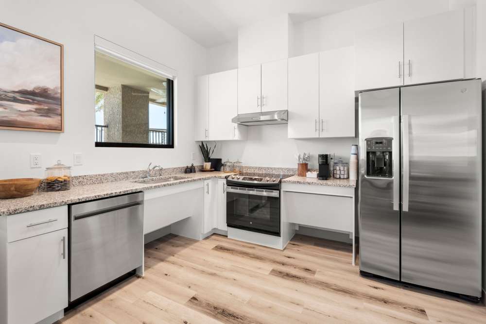 Clubhouse kitchen with side by side refrigerator at Olympus at Arroyo Verde in Tucson, Arizona