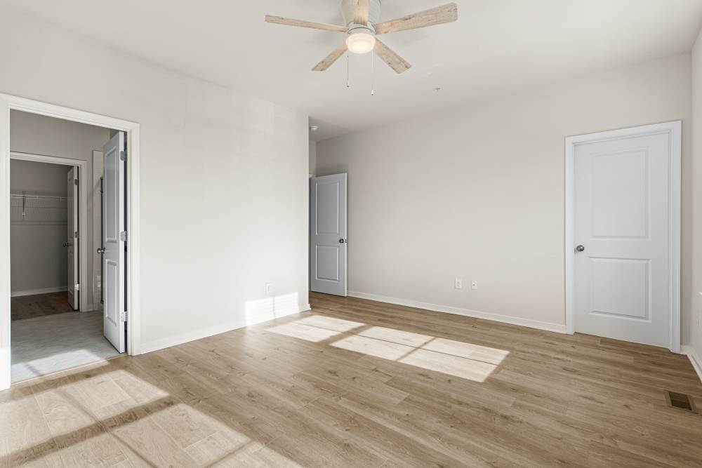 Bedroom with ceiling fan and large closet at The Westbrook at Brewer's Row in Richmond, Virginia