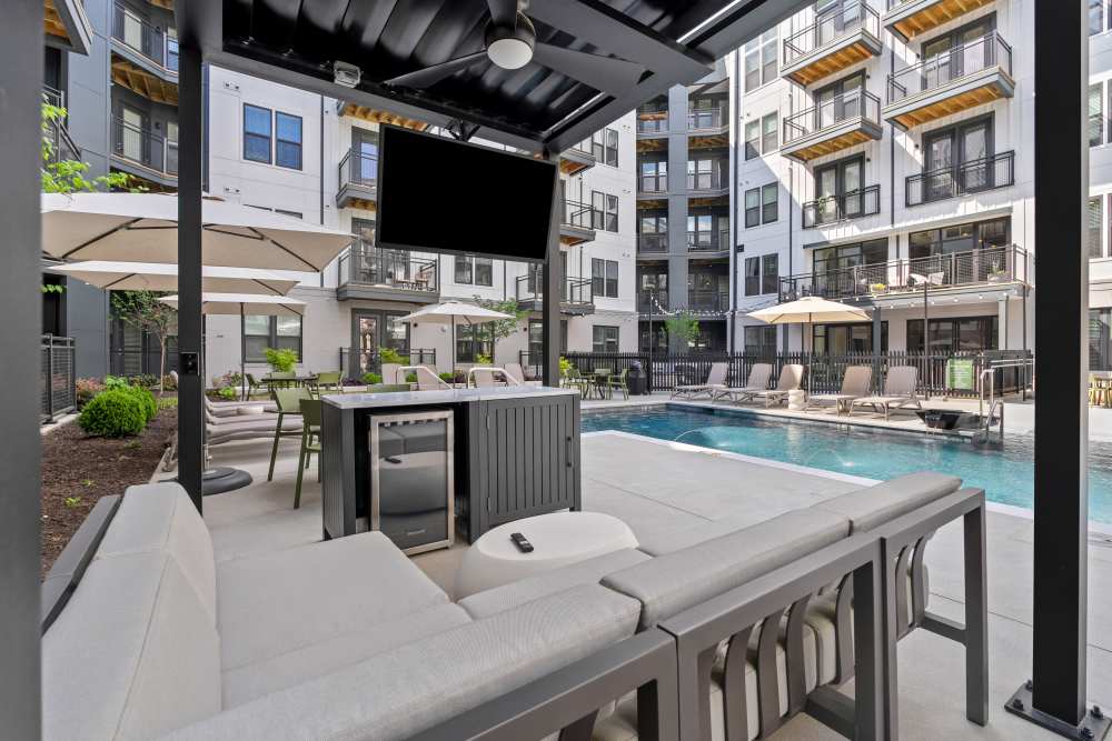 Poolside lounge with TV at The Alder on Dabney in Richmond, Virginia
