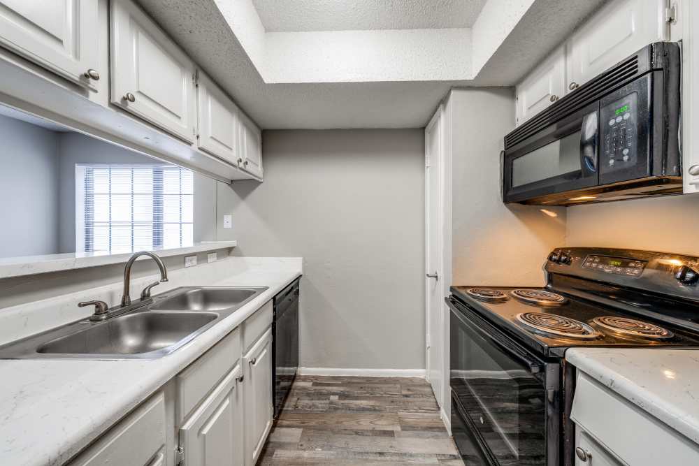 Apartment kitchen with white cabinetry at Icon Apartments in San Antonio,Texas