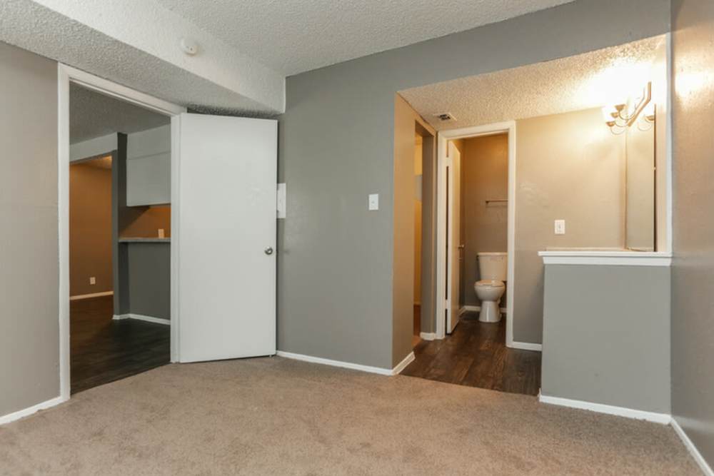 Bedroom with attached bathroom at Palatia Apartment Homes in San Antonio, Texas