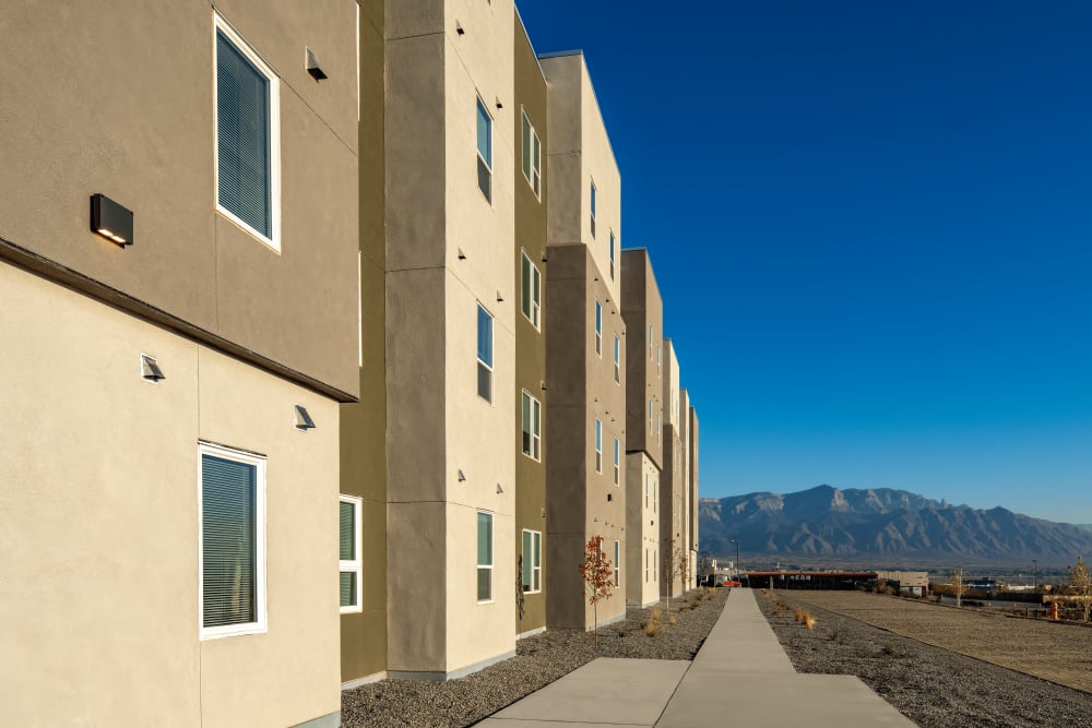 Sidewalk with view of mountains at Casa de Encantada Senior Apartments in Rio Rancho, New Mexico