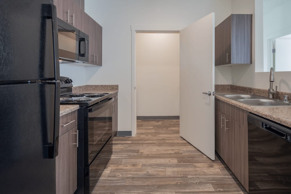 Kitchen with blak appliances at Casa de Encantada Senior Apartments in Rio Rancho, New Mexico