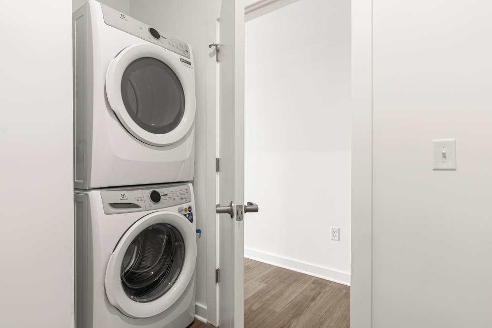 Stacked washer and dryer in an apartment at The Alder on Dabney in Richmond, Virginia
