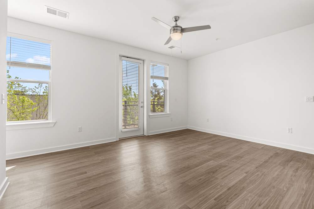Bedroom with ceiling fan and access to balcony at The Alder on Dabney in Richmond, Virginia