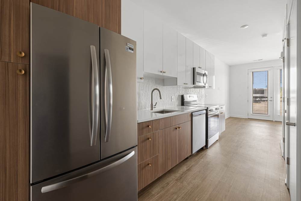 Kitchen with french-door refrigerator with ice maker at The Alder on Dabney in Richmond, Virginia