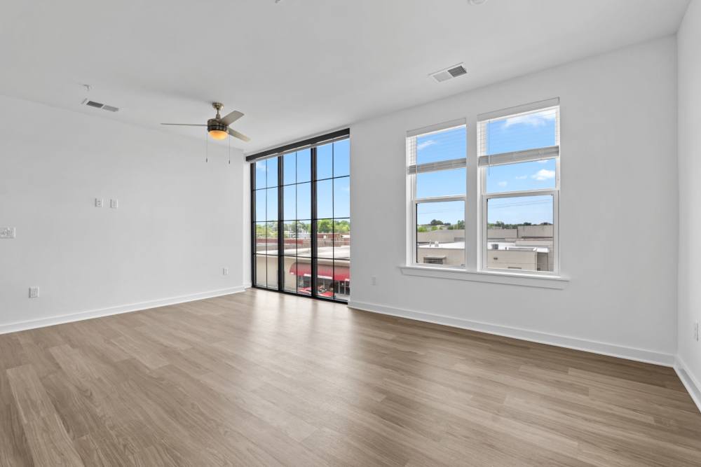 Apartment with glass window and wood-style flooring at The Alder on Dabney in Richmond, Virginia