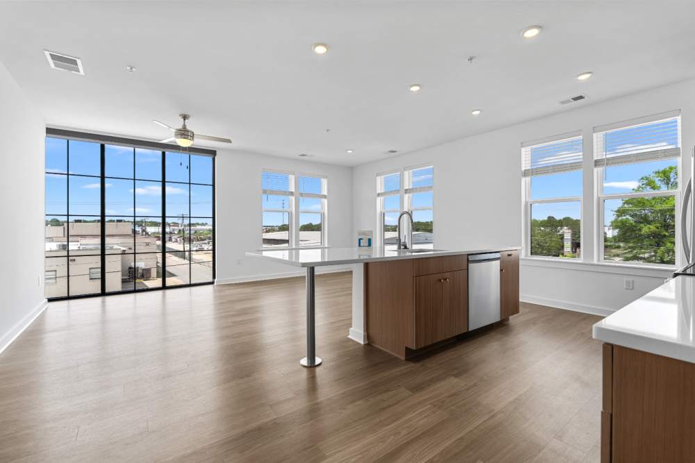 Well-lit apartment home with big windows and kitchen island at The Alder on Dabney in Richmond, Virginia