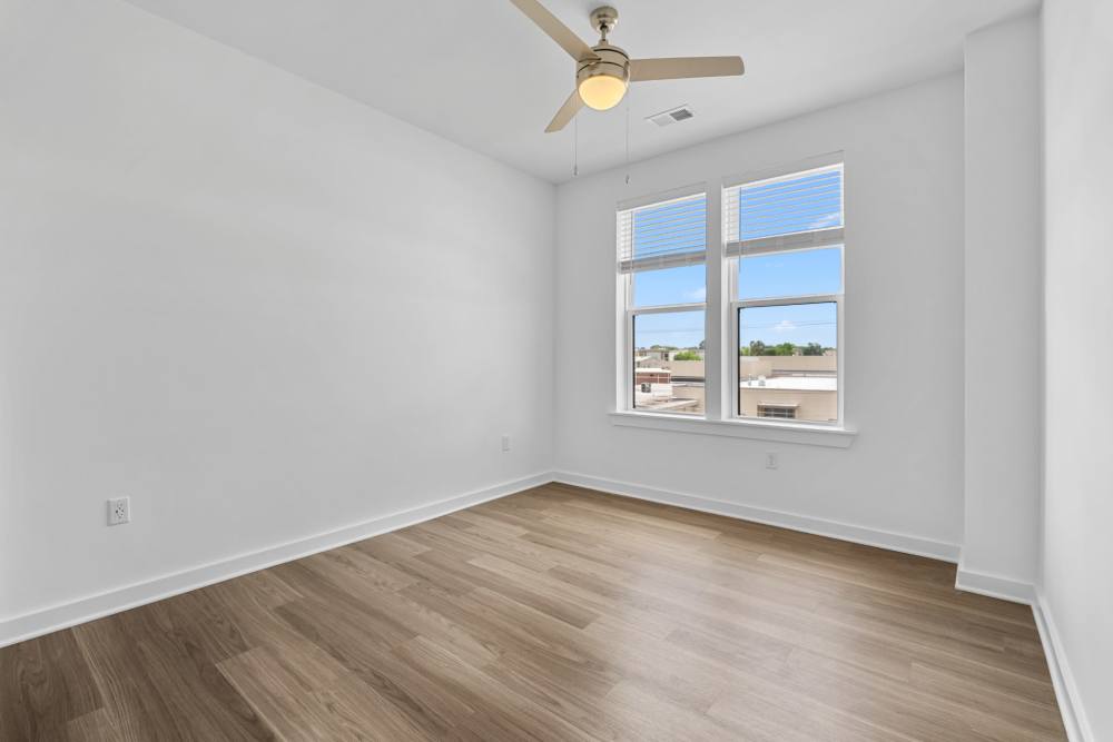 Bedroom with window and ceiling fan at The Alder on Dabney in Richmond, Virginia