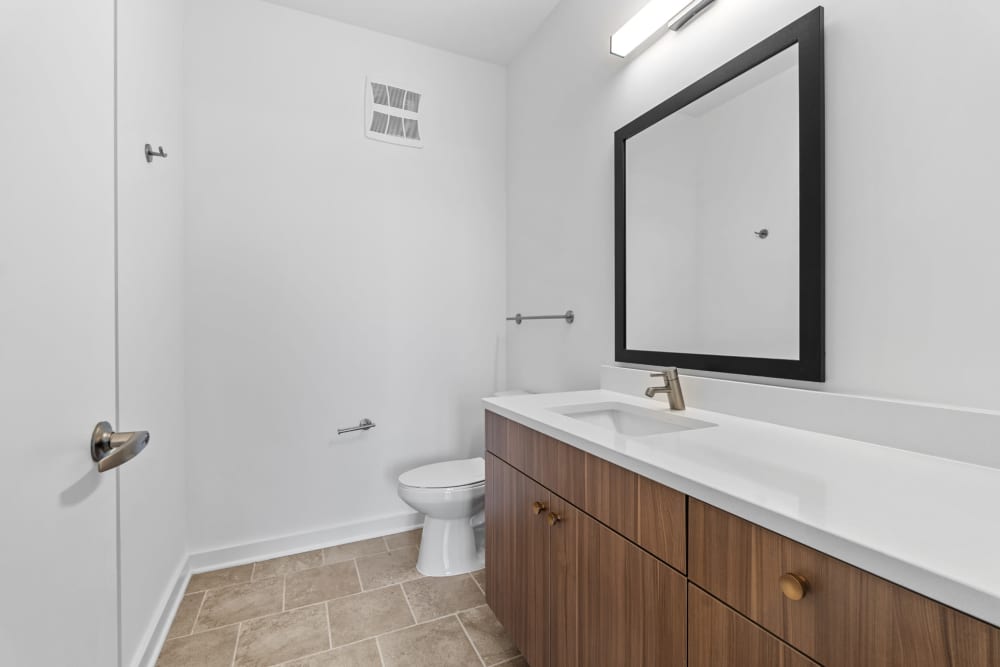 Wooden cabinet with vanity mirror in the bathroom at The Alder on Dabney in Richmond, Virginia
