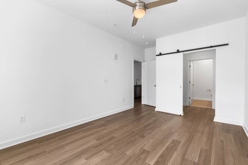 Bedroom with closet and wood-style flooring at The Alder on Dabney in Richmond, Virginia