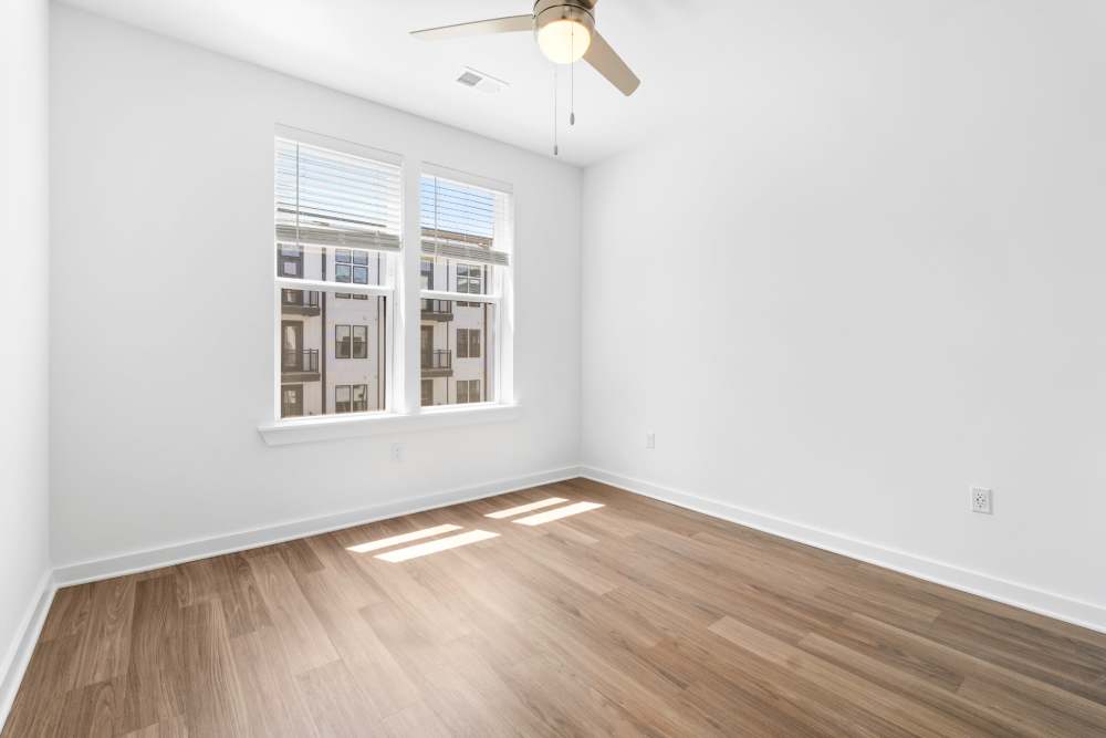 Bedroom with wood-style flooring at The Alder on Dabney in Richmond, Virginia