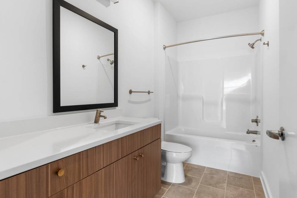 Bathroom with white sink and tub at The Alder on Dabney in Richmond, Virginia