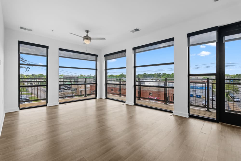 Well-lit living room with big windows at The Alder on Dabney in Richmond, Virginia