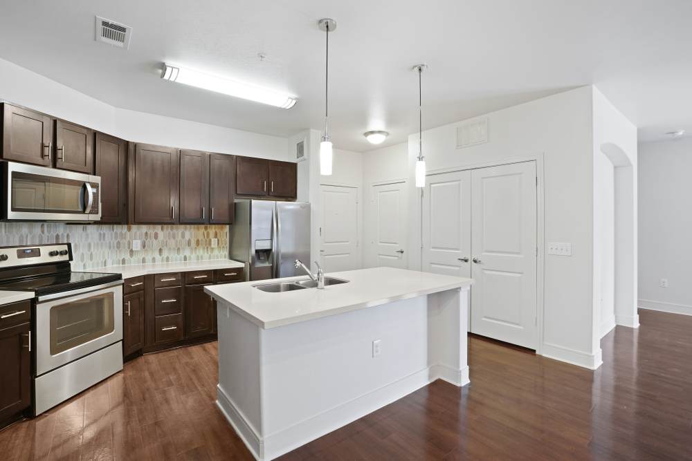 Kitchen with cupboards and breakfast island at Trinity Bluff & Trinity District in Fort Worth, Texas