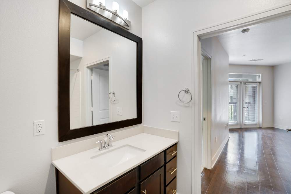 Bright bathroom with mirror, sink at Trinity Bluff & Trinity District in Fort Worth, Texas