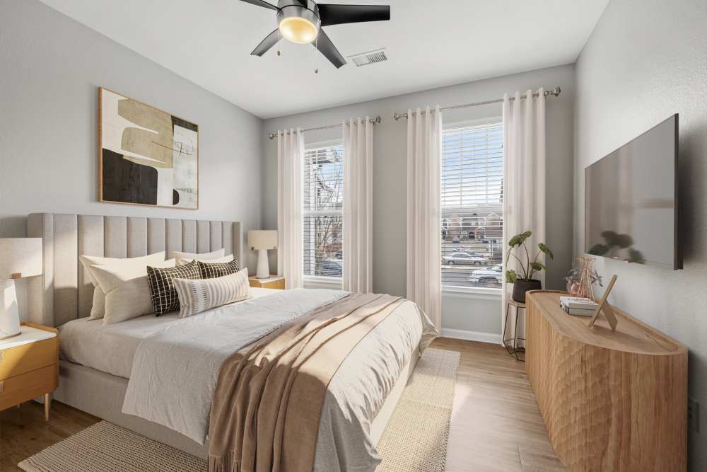 Lots of natural sunlight showing through in elegantly furnished bedroom at Briargate on Main in Parker, Colorado