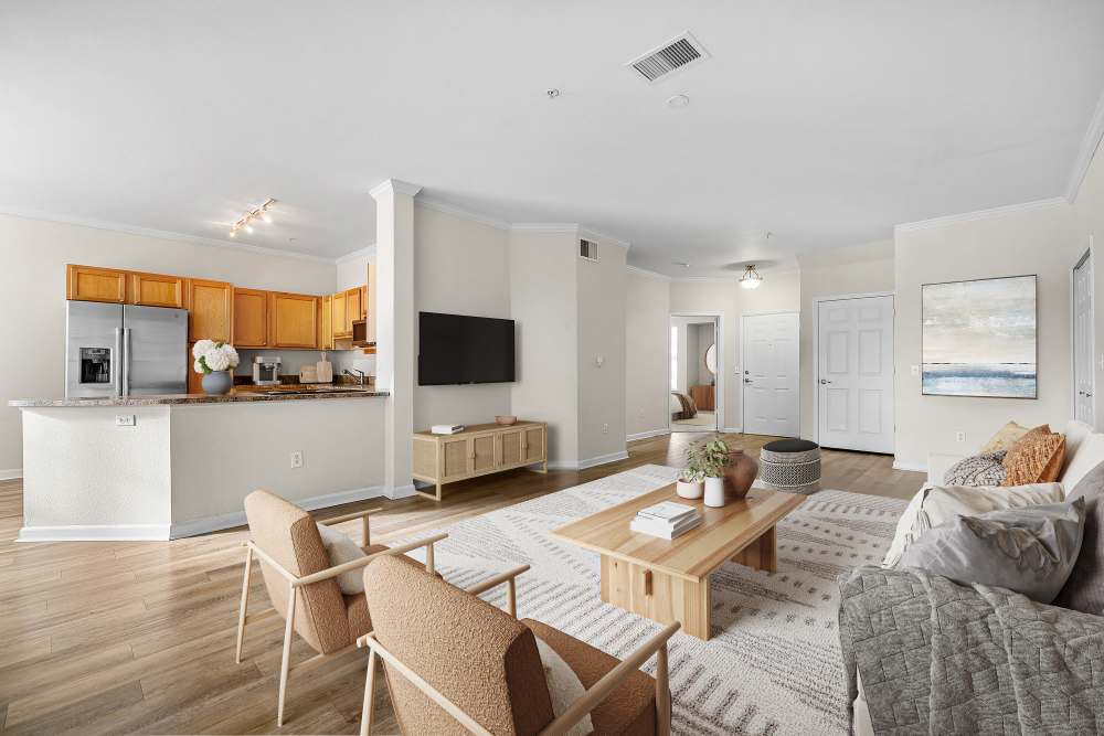 Large kitchen with big breakfast bar and furnished living room at Briargate on Main in Parker, Colorado