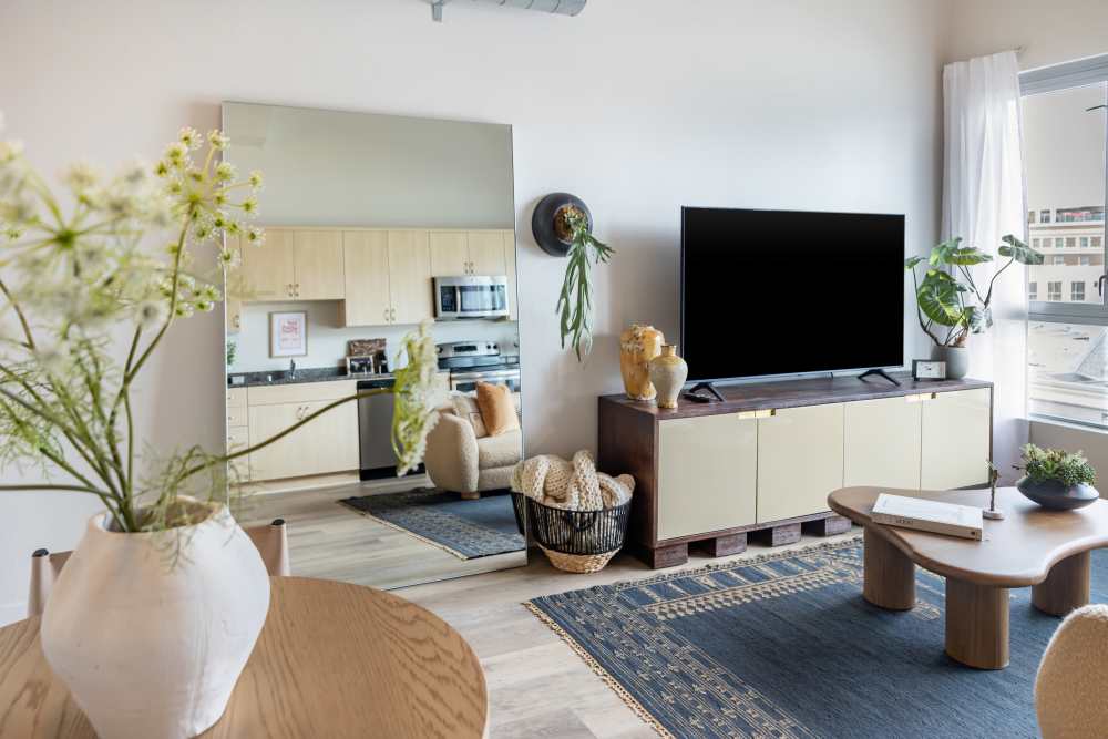 Updated kitchen with stainless steel appliances, including refrigerator and dishwasher at Nova Apartment Homes in San Diego, California