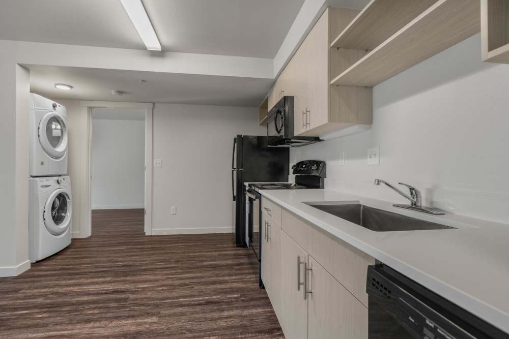 Modern kitchen with wooden cabinets and stainless-steel appliances at Blanton Commons in Beaverton, Oregon
